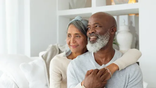 Couple spending time together and laughing on a sofa