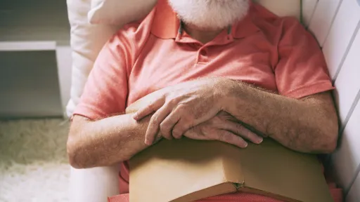 Senior man fell asleep on sofa after reading book