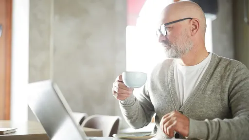 Introspective mature man at work in cafe