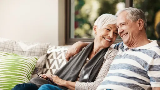 Shot of a happy senior couple relaxing together on a sofa outside at home