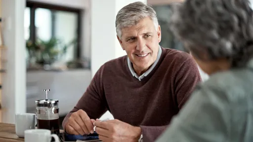 Shot of a mature man having a conversation with his wife blurred out in the foreground