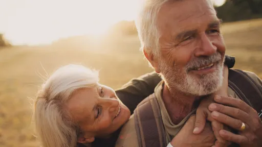 Photo of an elderly couple, who still enjoy in each other, is on a hiking trip together