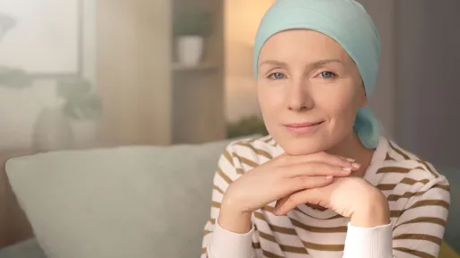 Young woman with cancer in headscarf indoors