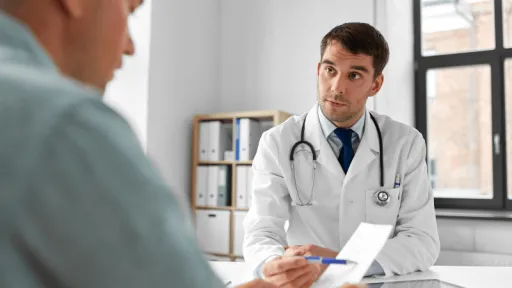 head and neck surgeon consulting with patient