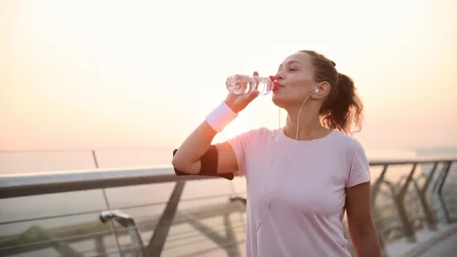 Woman drinking water on a run