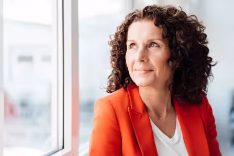 Woman in orange suit jacket