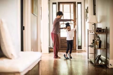 Mom and young daughter dancing