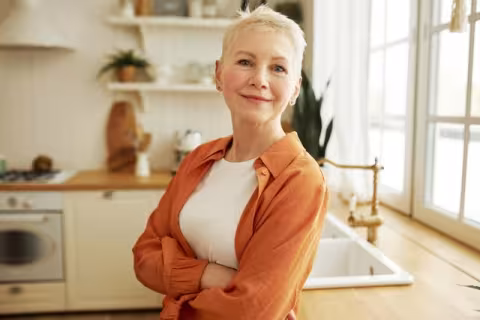 middle-aged woman standing in kitchen