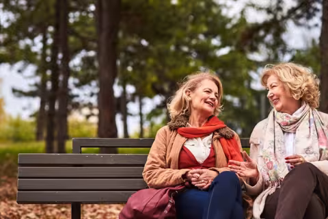 Friends chatting on a park bench